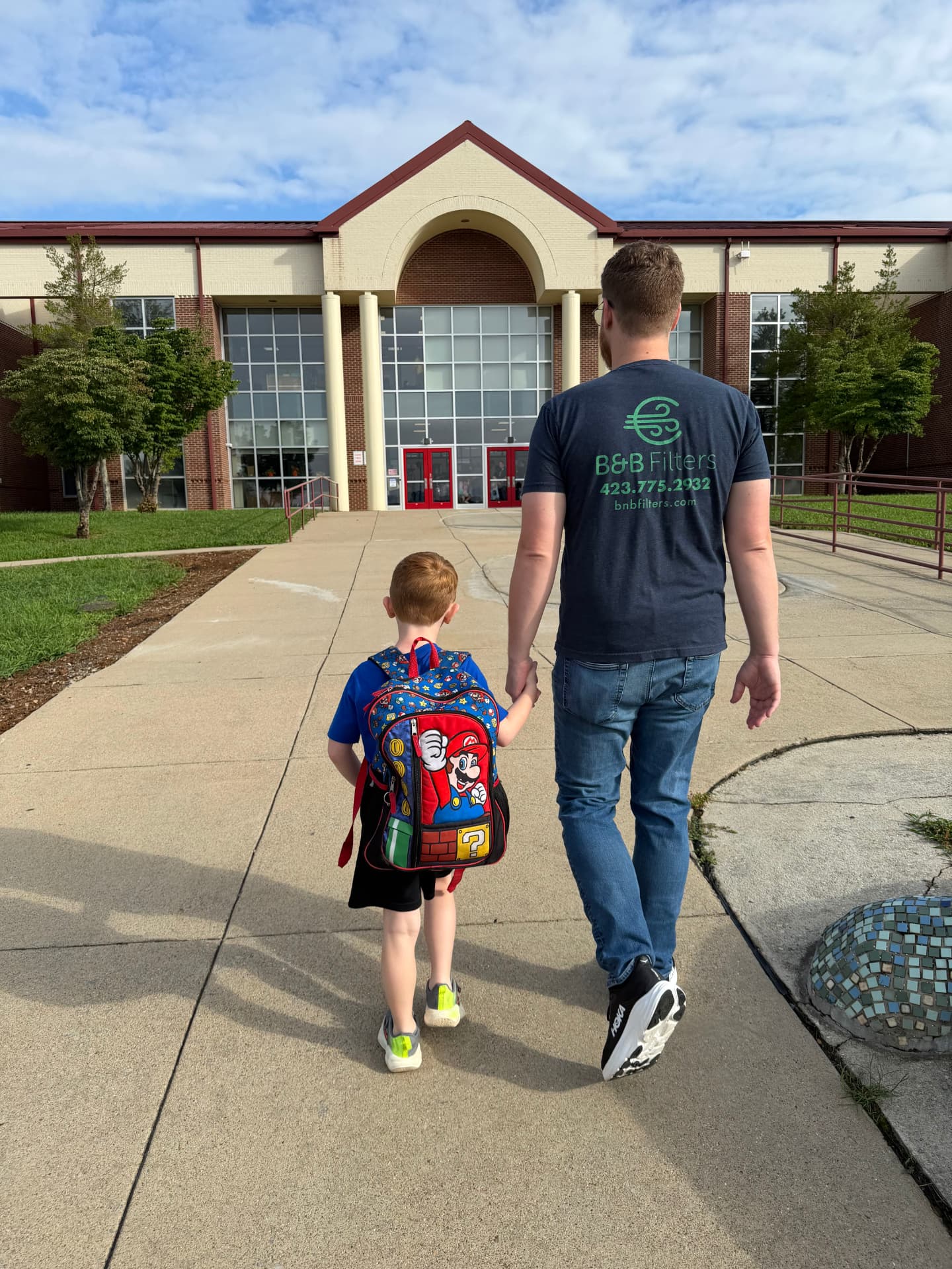 Ryan Berkley walking his child into a Johnson City school.